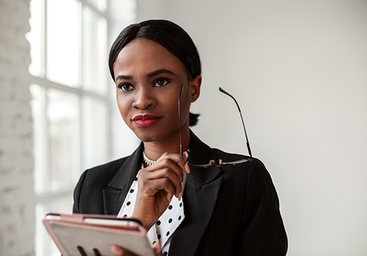 Woman holding her specs in her hand