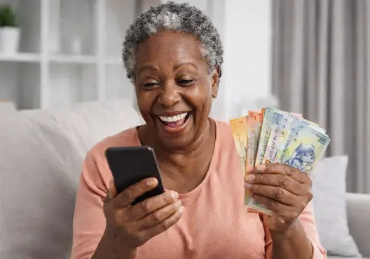 Standard Claims A woman holding a phone and cash